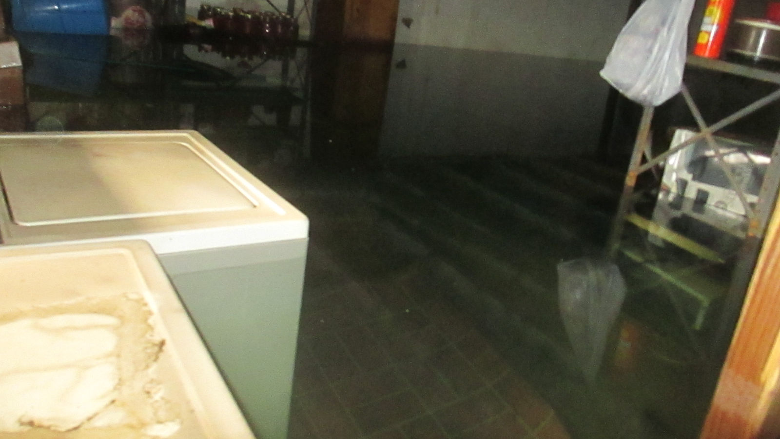 Flooded basement, nearly to top of washing machine